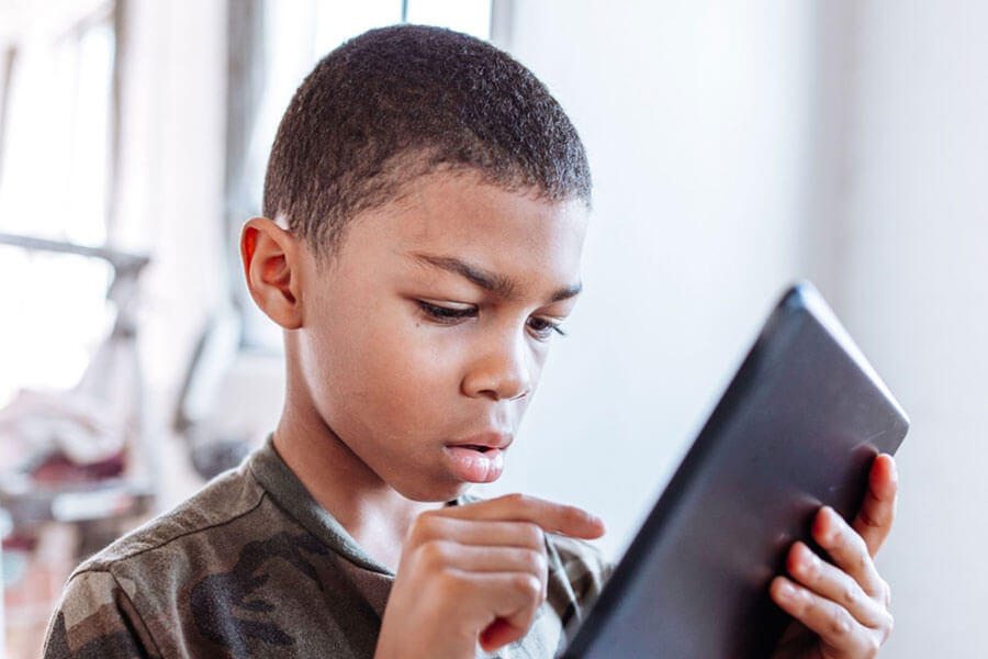 Young Student Learns Virtually On Tablet
