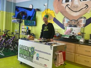 Mr. Ritz behind his portable kid safe kitchen that has the "Green Bronx Machine" written on it. 
