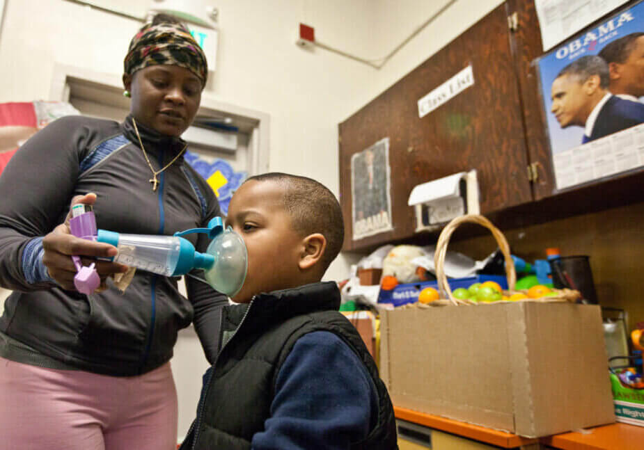 Shameka Bibb gives her son Sarquan Holland Jr., age 5, his asthma inhaler at school before she leaves him for the day.  Hollands asthma is so severe that he has been on Prednisone since he was three and is on the strongest dose of inhaler, not usually given to children.  (Photo by Deborah Svoboda)